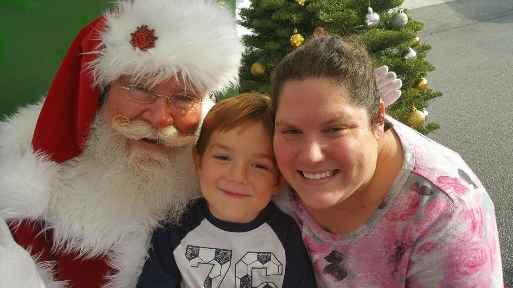 Santa True with a mom and son at the farmer's market Santa True with a mom and son at the farmer's market