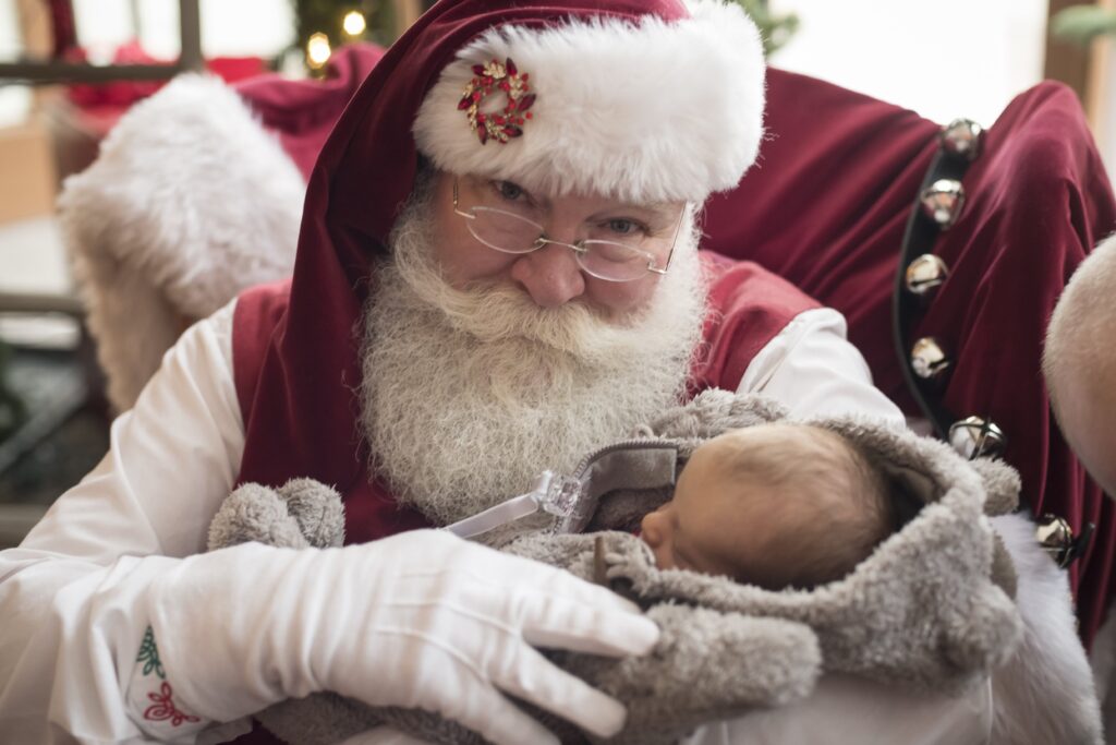 Santa True holding a very young infant Santa True holding a very young infant