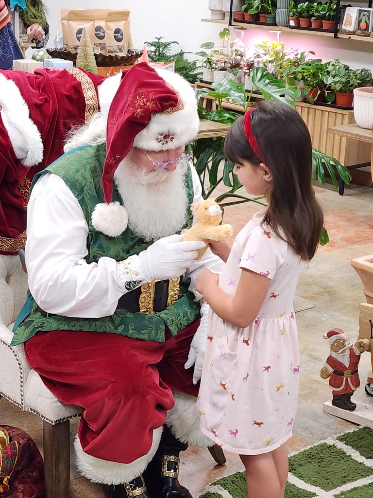 Santa True with a child and stuffed toy Santa True with a child and stuffed toy